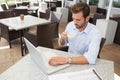 Frowning young businessman working at laptop Royalty Free Stock Photo