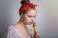 Frowning young Caucasian woman girl holding ice cream looks grumpy as if doesn`t want to share or angry, annoyed