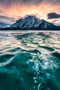 Frozen Abraham Lake with rocky mountains and natural bubbles frost in the morning on winter at Banff national park Royalty Free Stock Photo