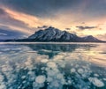 Frozen Abraham Lake with rocky mountains and natural bubbles frost in the morning on winter at Banff national park Royalty Free Stock Photo