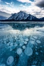 Frozen Abraham Lake with rocky mountains and natural bubbles frost on winter at Kootenay Plains, Canada Royalty Free Stock Photo