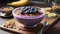 Frozen acai in a bowl served with granola and banana on rustic cutting board