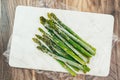 Frozen asparagus stalks close up on marble board