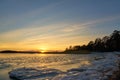 Frozen beach and icy sea on a sunset in Ruissalo, Finland. Royalty Free Stock Photo