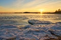 Frozen beach and icy sea on a sunset in Ruissalo, Finland. Royalty Free Stock Photo