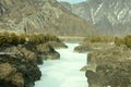 The frozen bed of a mountain river squeezed into a narrow stone canyon in a picturesque valley Royalty Free Stock Photo