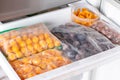 Frozen berries in the freezer. Frozen plums, cherry plums on the freezer shelf Royalty Free Stock Photo