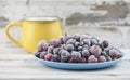 Frozen berries fruits background in ceramic plate close up.Fruits with frost. on vintage white wooden planks, blank space for text Royalty Free Stock Photo