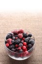 Frozen berries in glass bowl burlap canvas Royalty Free Stock Photo