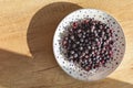 Frozen berries on a plate top view on a wooden background. Royalty Free Stock Photo