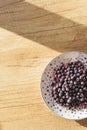 Frozen berries on a plate top view on a wooden background. Template for the menu Royalty Free Stock Photo