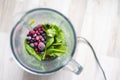 Frozen berries and spinach leaf ready for smoothie blending