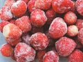 Frozen berries.Top view. Frozen delicious Strawberries, closeup. Assorted frozen berries background. Strawberries on blue