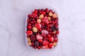 Frozen berry mix in a plastic container Royalty Free Stock Photo