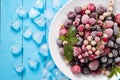 Frozen berry on turquoise background top view Royalty Free Stock Photo