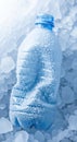 Frozen blue plastic water bottle covered in ice crystals on a bed of icy crushed ice for refreshment concept Royalty Free Stock Photo