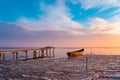 frozen boat in winter on the lake at sunrise Royalty Free Stock Photo