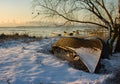 frozen boat in winter at sunrise
