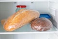 Frozen bread in the home refrigerator. The frozen products. Long food storage concept