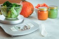 Frozen broccoli for baby first lure on kitchen scale Royalty Free Stock Photo