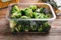 Frozen broccoli on wooden table. Vegetable preservation Royalty Free Stock Photo