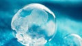 frozen bubble with bokeh background. Beautiful frosty patterns on frozen soap bubble