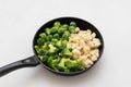 Frozen cabbage set in frying pan on a white background. Cauliflower, broccoli and brussels sprouts. Frozen vegetables Royalty Free Stock Photo