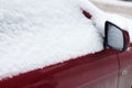 Frozen car covered snow in winter day, view front window windshield and hood on snowy background . Royalty Free Stock Photo