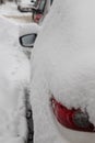 Frozen car covered snow in winter day, view side window on snowy forest background Royalty Free Stock Photo