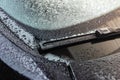 Frozen car windscreen wipers on winter morning. Royalty Free Stock Photo