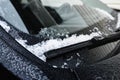 Frozen car windscreen wipers on winter morning.