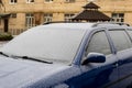 A frozen car windshield is covered in ice and snow on a winter day. Close up view Royalty Free Stock Photo