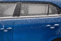 Frozen car windshield covered with ice and snow on a winter day. Royalty Free Stock Photo