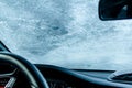 Frozen car windshield covered with ice and snow on a winter day Royalty Free Stock Photo