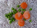 Frozen carrots and peas on crumpled tinfoil