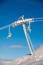 Frozen chair lift at snow resort in winter mountains on sunny da