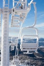 Frozen chair lift at snow resort in winter mountains on sunny da