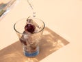 Frozen cherry inside a glass, fresh drink and summer concept
