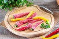 Frozen chili pepper on a wooden board on the table. Frozen vegetables. Frozen food