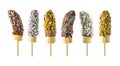 Frozen chocolate dipped banana pops with an assortment of sprinkles, nuts and coconut isolated on white