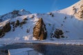 Frozen chunks of ice floating down frozen river flowing from Iceland\'s Skogafoss waterfall