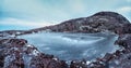 Frozen clear mountain lake, panoramic winter view. Amazing Arctic landscape with a high-altitude frozen lake Royalty Free Stock Photo