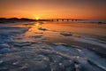 Frozen Coastal Landscape With Ice And Bridge At Dramatic Sunset Royalty Free Stock Photo