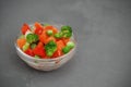 Frozen Colorful Vegan Healthy Vegetables. Brocolli, Carrots, Peas, Pepper. vertical Image. Gray Background.