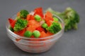 Frozen Colorful Vegan Healthy Vegetables. Brocolli, Carrots, Peas, Pepper. vertical Image. Gray Background. Royalty Free Stock Photo