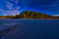 Frozen cox hollow lake and pine lined rock bluff on a sunny winter day Royalty Free Stock Photo