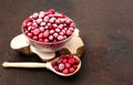 Frozen cranberries in a bowl close up. Frozen berries with a wooden spoon on a brown background. Copy space Royalty Free Stock Photo