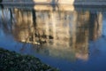 Frozen Dambovita river water reflecting building in Bucharest in winter Royalty Free Stock Photo