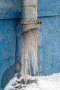 Frozen downpipe. Icicles from the downspout Royalty Free Stock Photo
