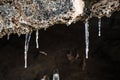 Frozen dripping water on the stone entrance of antique cave in winter Royalty Free Stock Photo